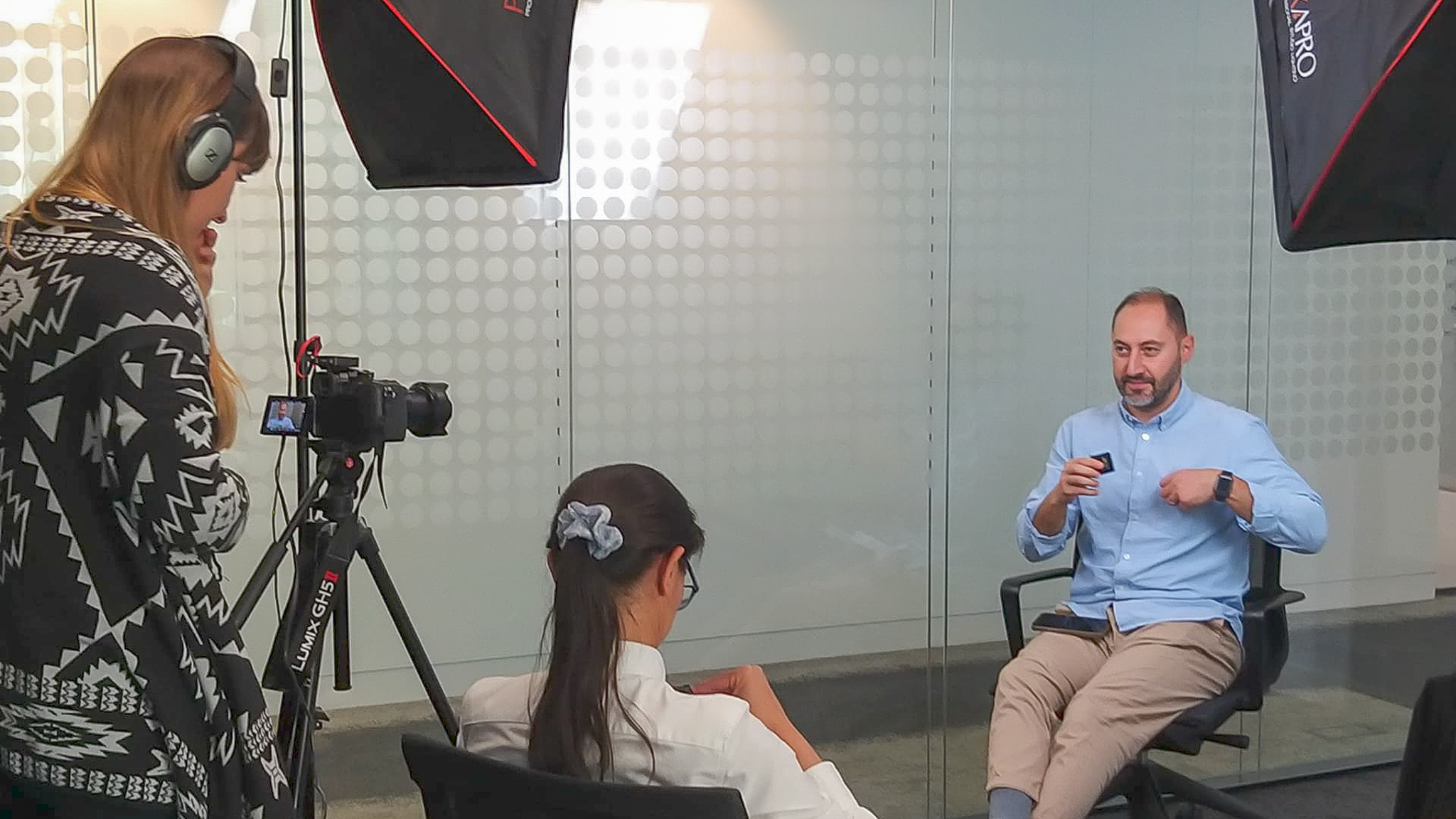 Two women and one man in a video training session.